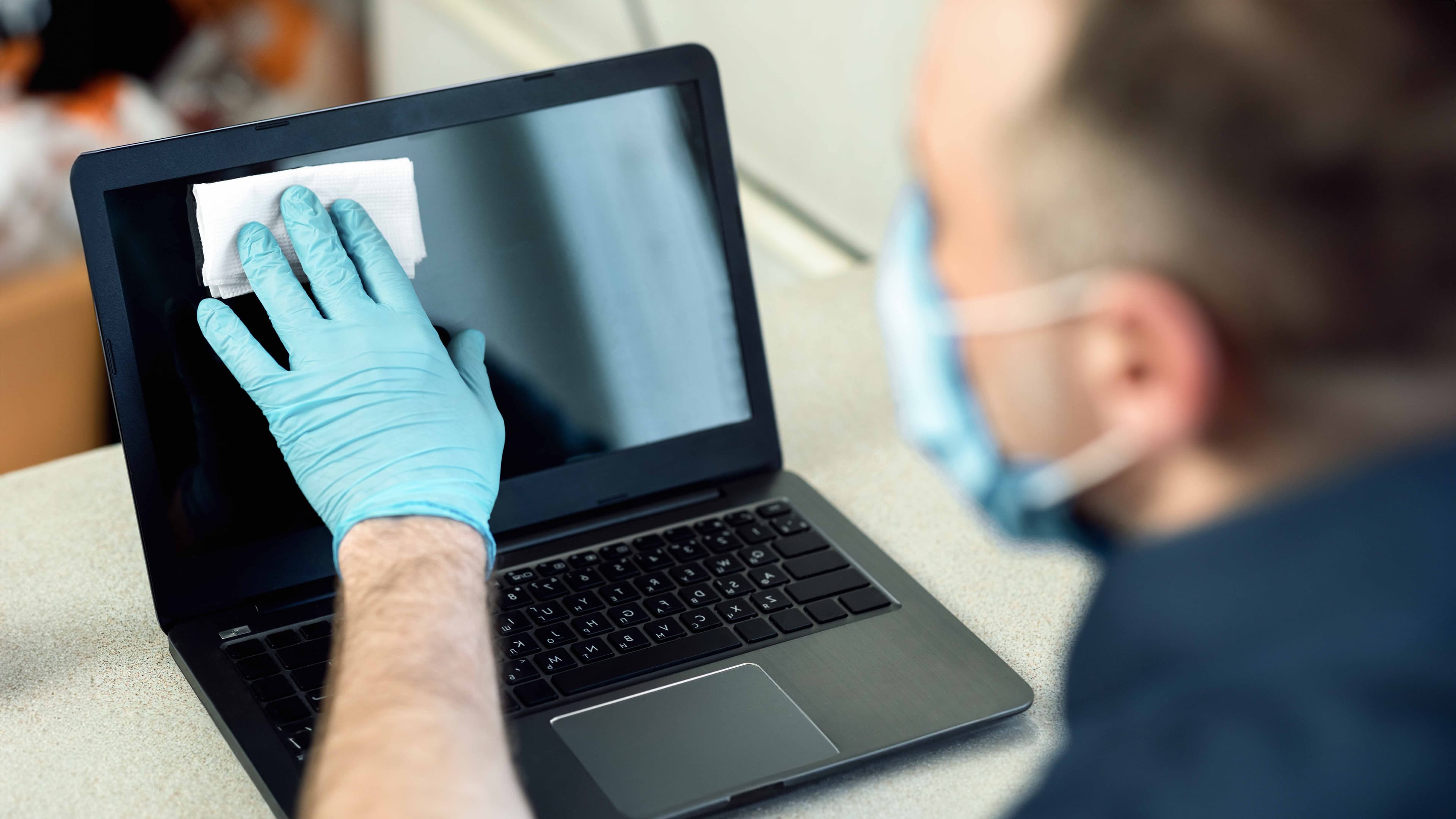 A laptop being assessed under grading lights