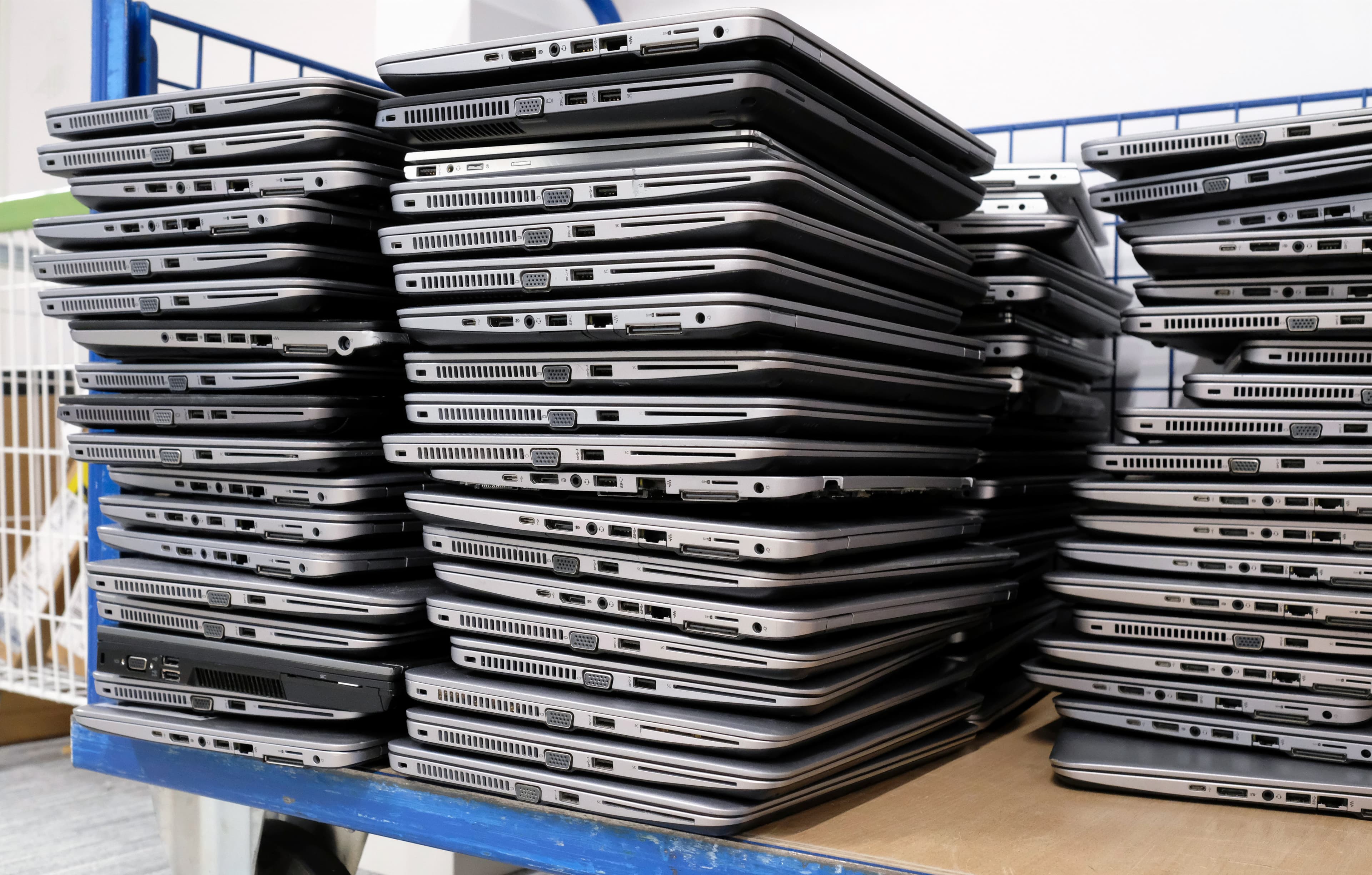Pallets of trade-in laptops arriving at the workshop